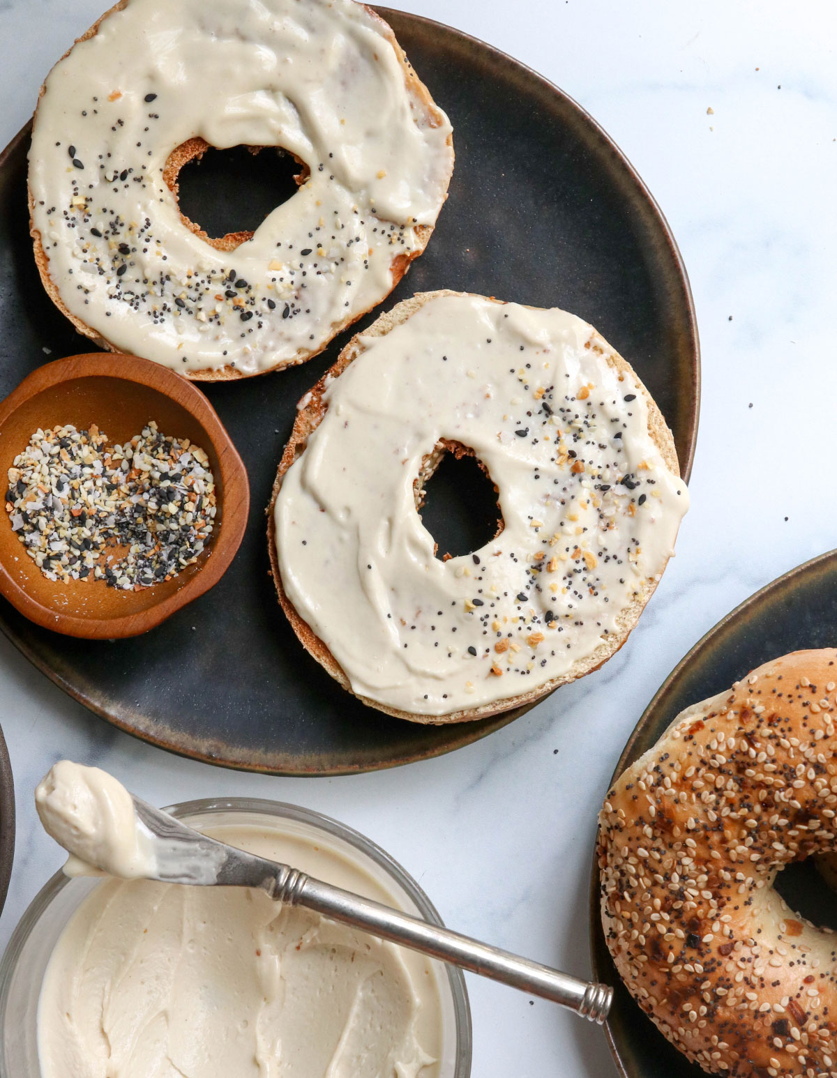 vegan cream cheese spread on a bagel with everything seasoning