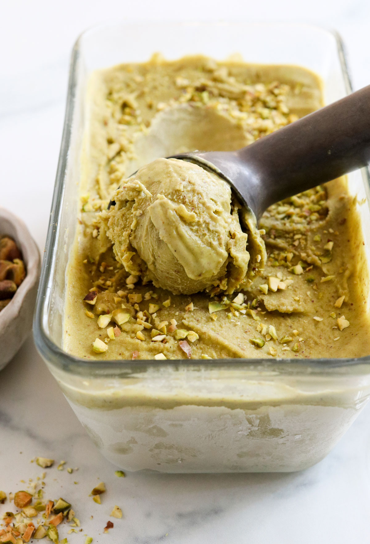 pistachio ice cream scooped from pan
