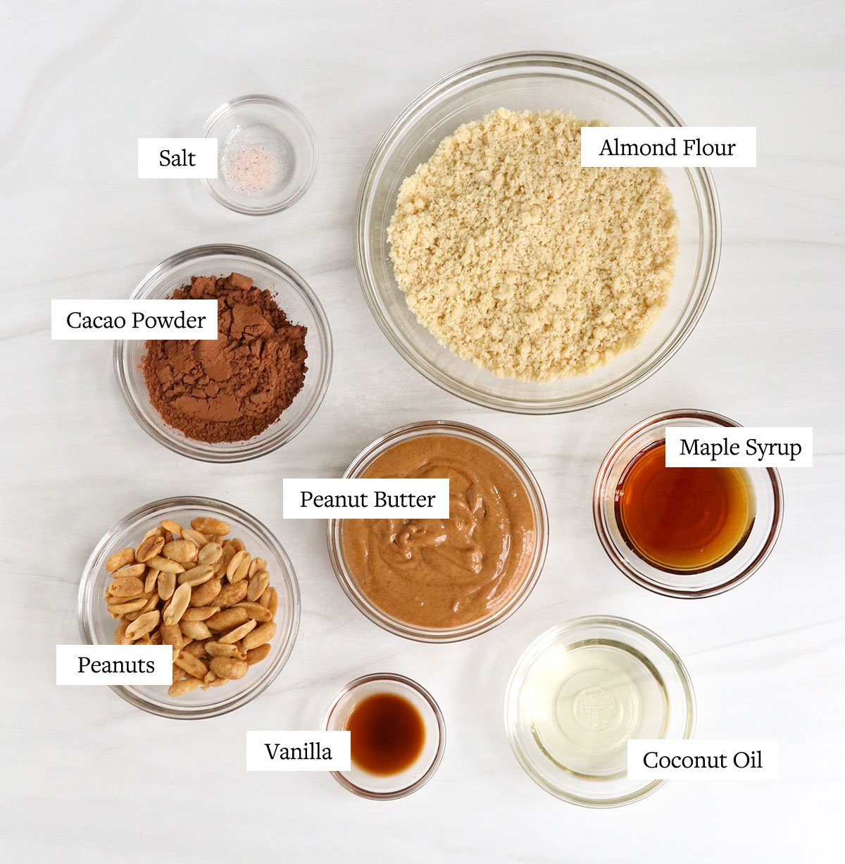vegan snickers ingredients labeled in glass bowls.