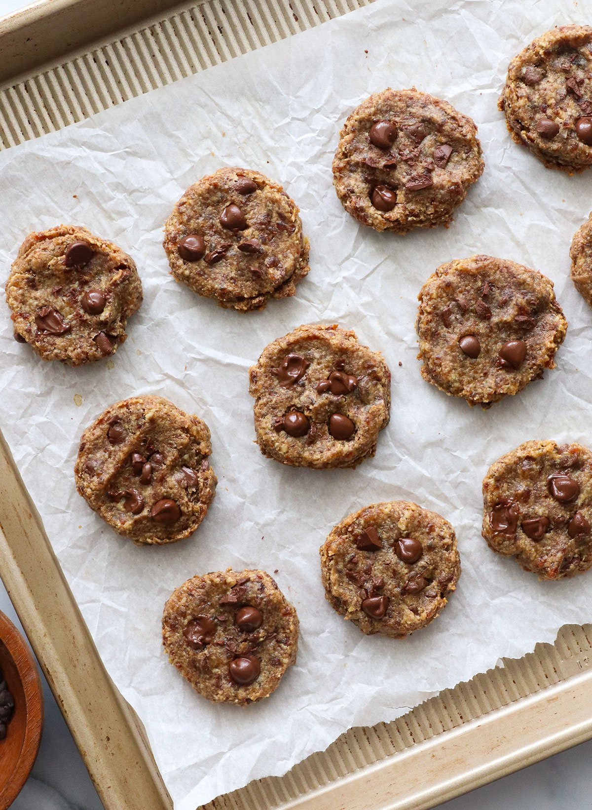 flattened cookies baked and cooled on a baking sheet. 