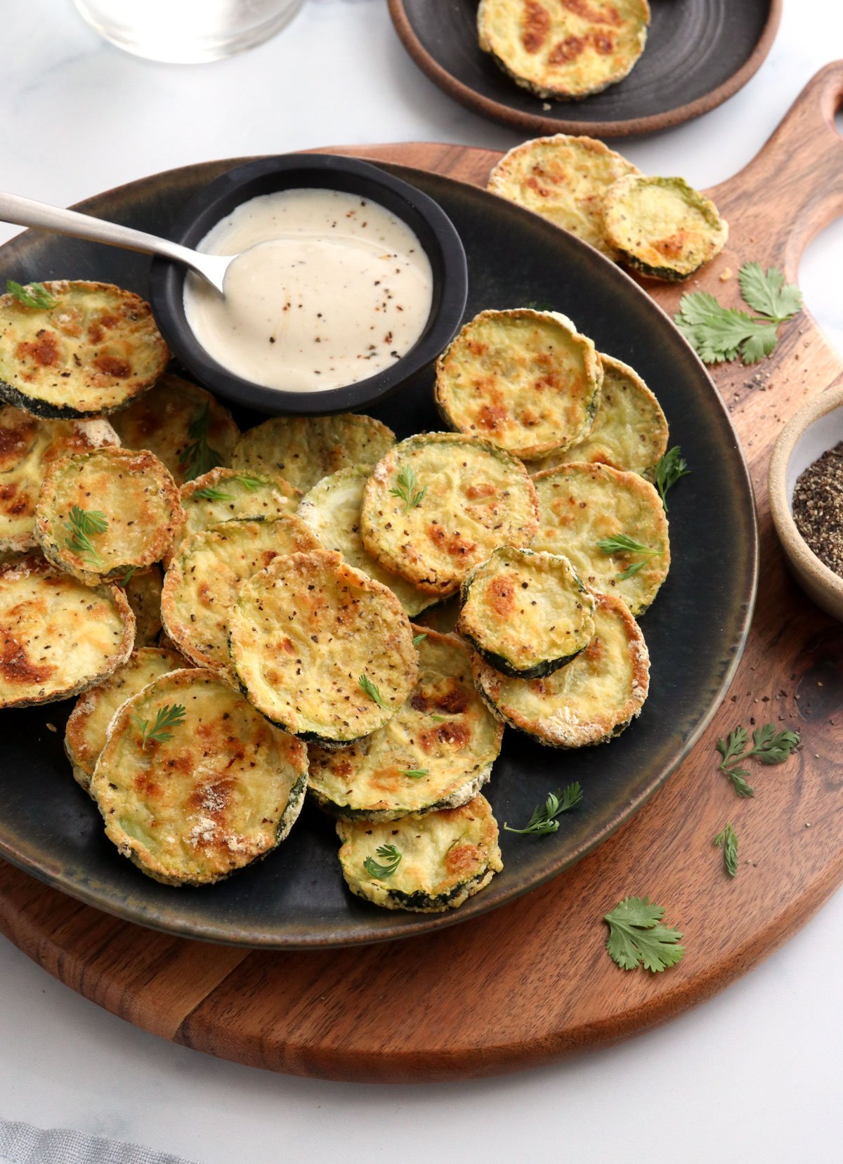 air fryer zucchini slices on black plate