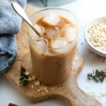 iced oat milk latte with spoon in glass