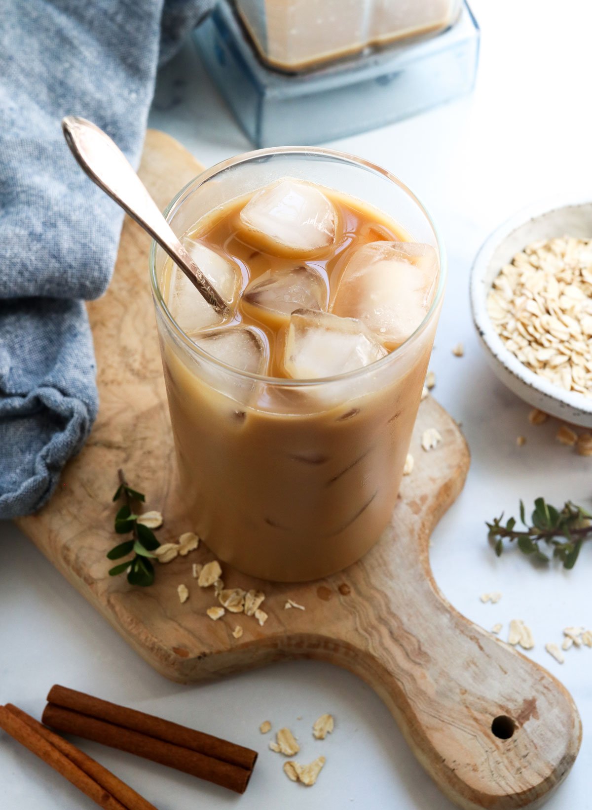 iced oat milk latte with spoon in glass