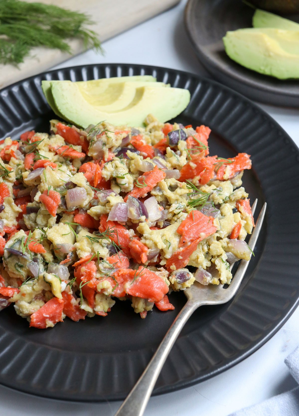 scrambled eggs and salmon on plate from the side angle