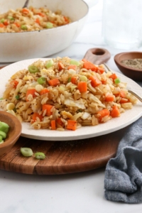 veggie fried rice on white plate with fork