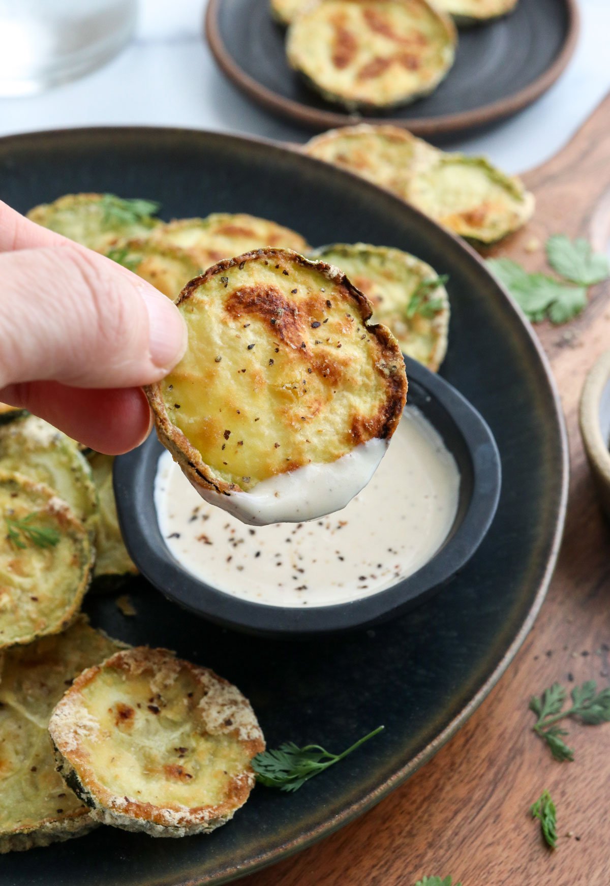 crispy zucchini chip dipped in tahini sauce