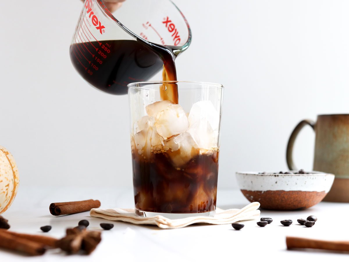 coffee poured into glass of ice