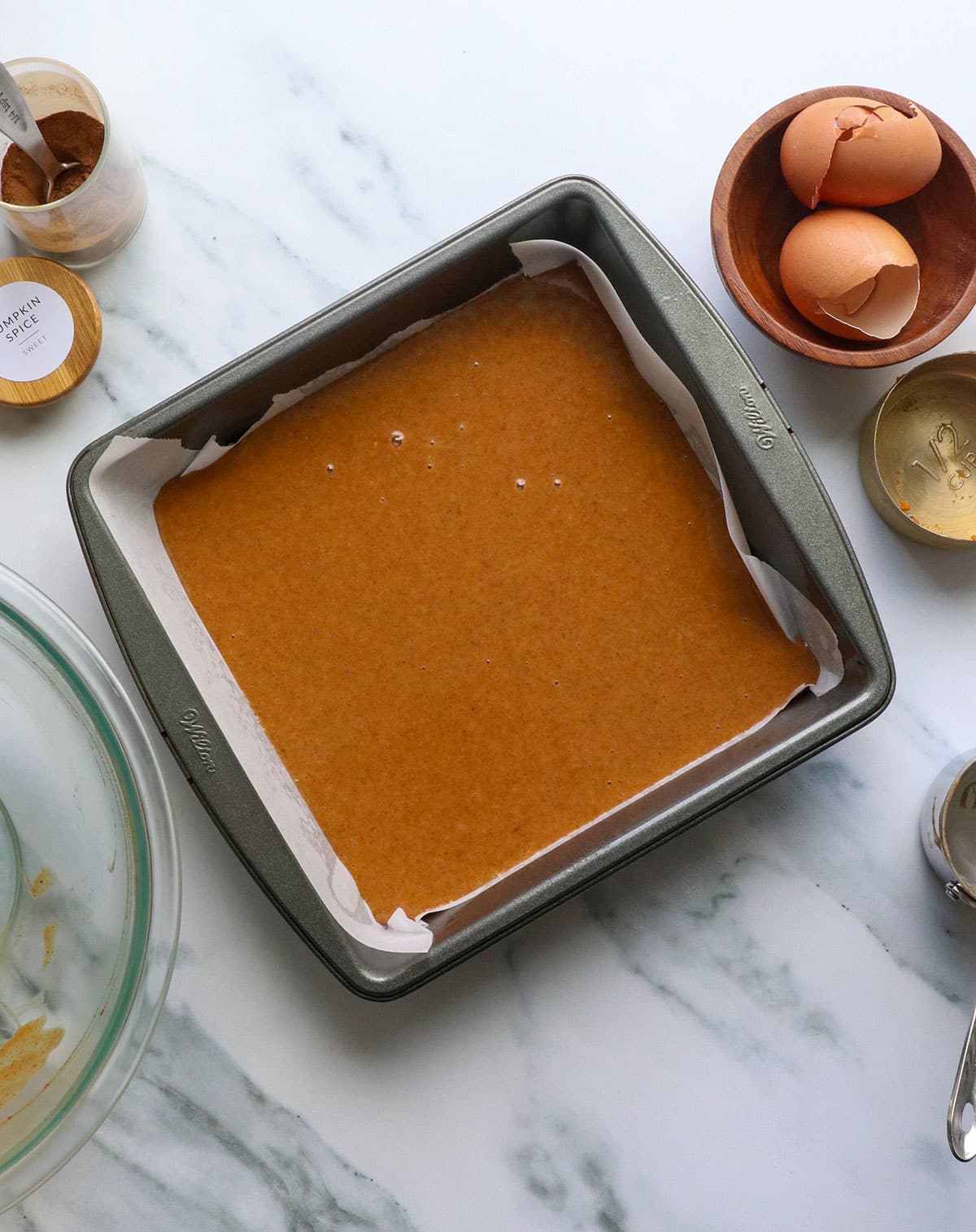 pumpkin bar batter poured into a square pan. 