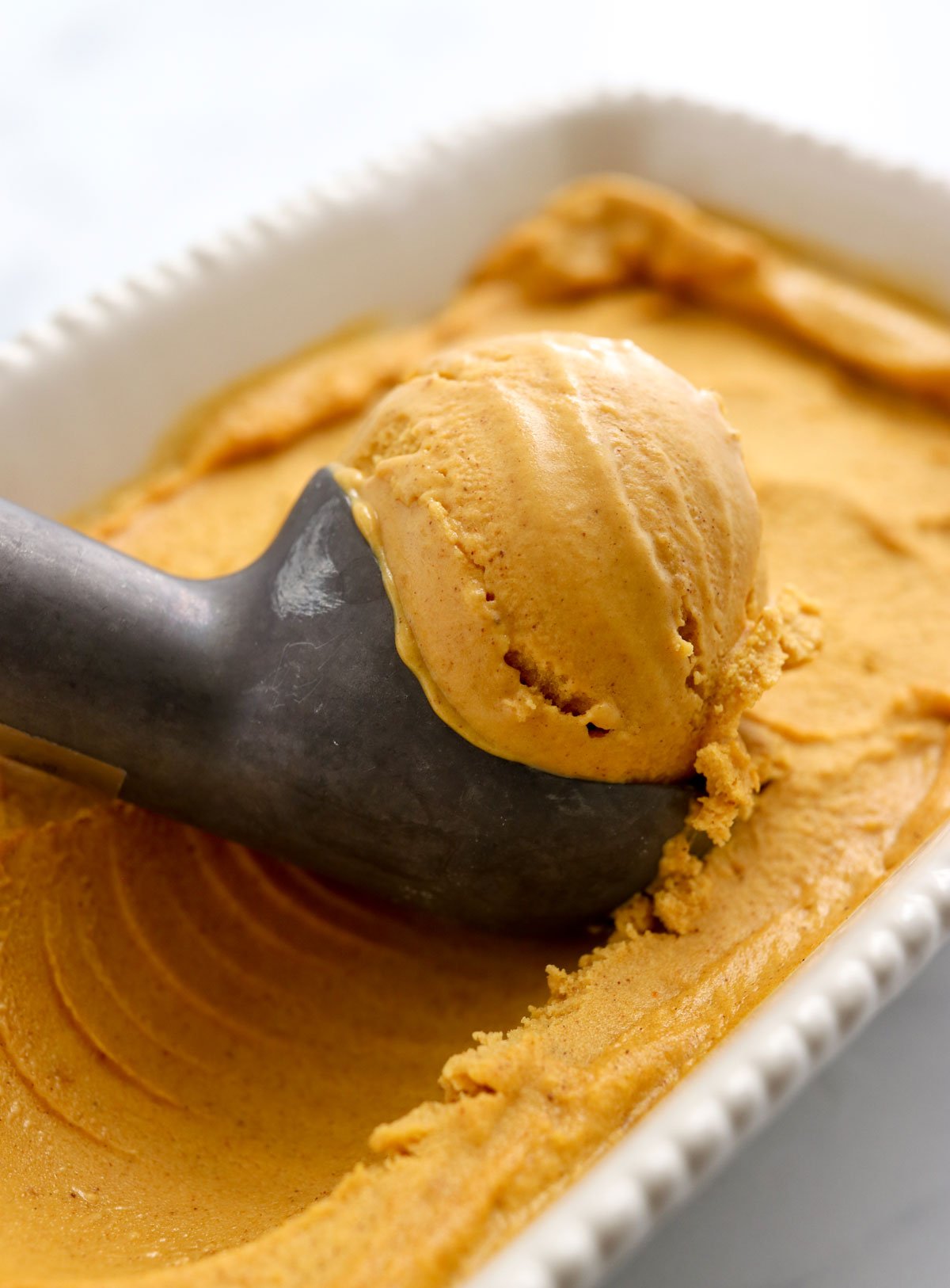 pumpkin ice cream scooped from dish