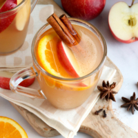 apple cider in glass with cinnamon sticks