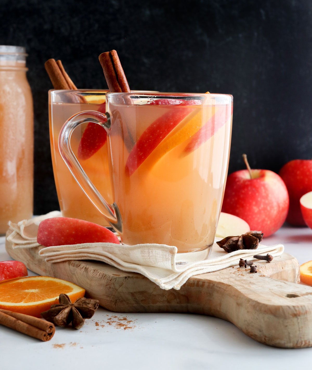 apple cider mugs in front of black surface