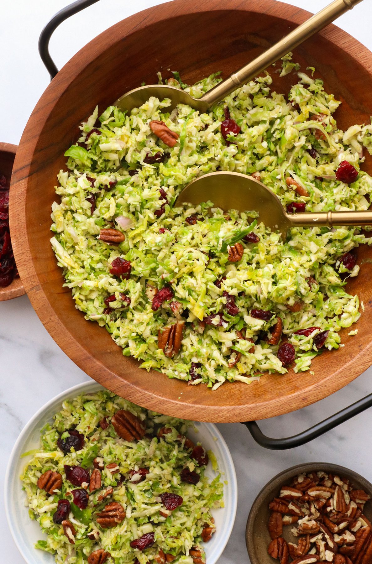 shredded brussel salad in a wooden bowl nearby. 