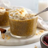 pumpkin chia pudding with whipped cream and walnuts on top