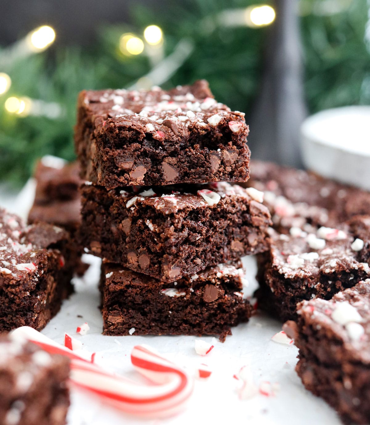 oat flour peppermint brownies stacked in front of garland