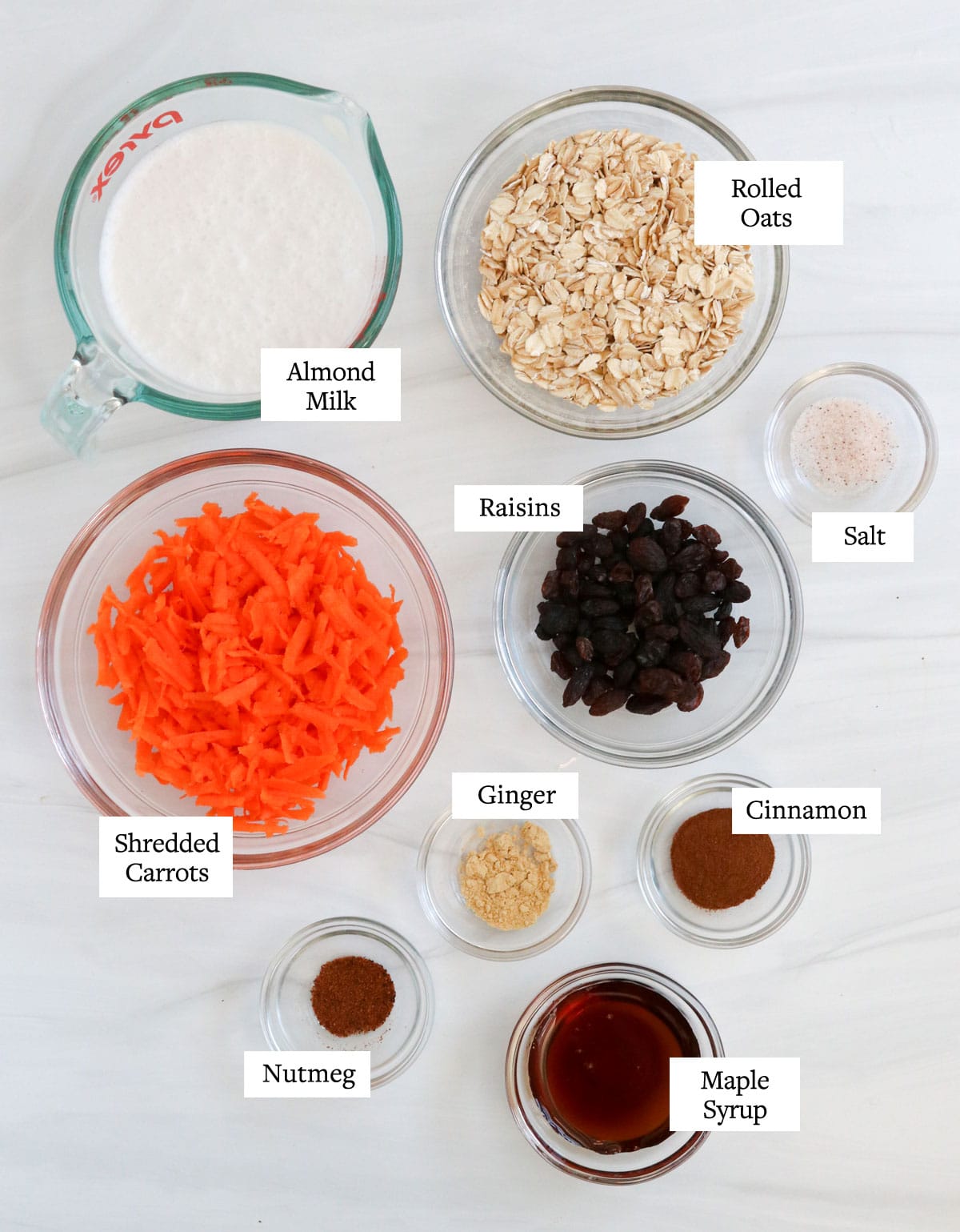 carrot cake oatmeal ingredients in glass bowls