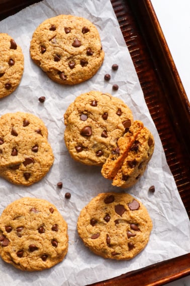 cashew butter cookies on a pan with chocolate chips.
