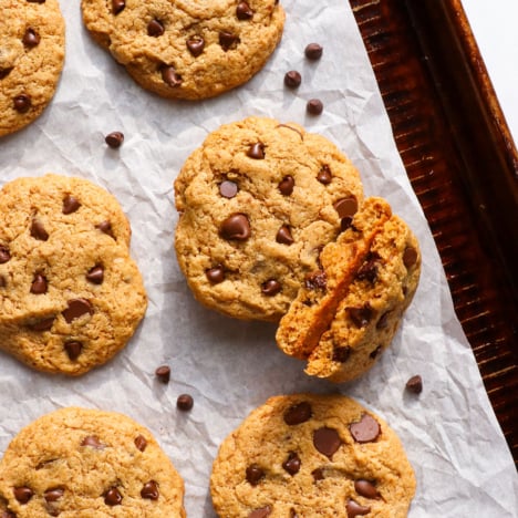 cashew butter cookies on a pan with chocolate chips.