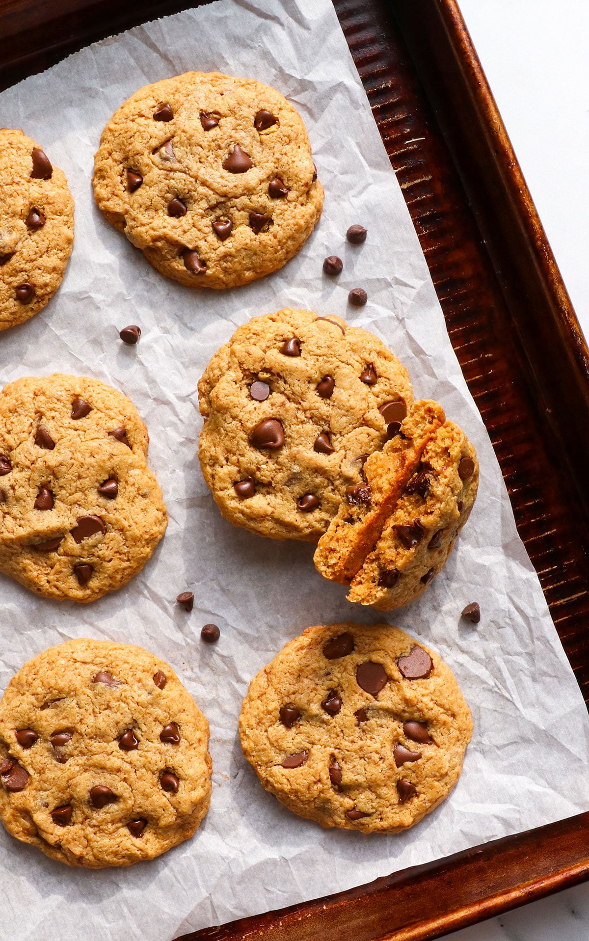 cashew butter cookies on a pan with chocolate chips.