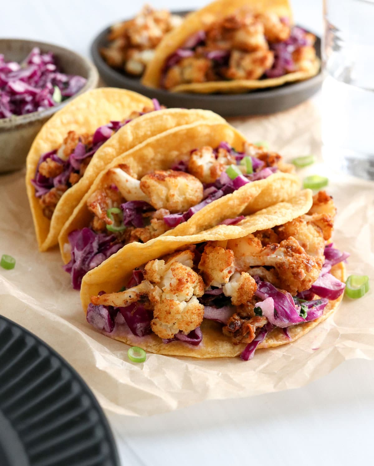 cauliflower tacos served with cabbage slaw in corn tortillas