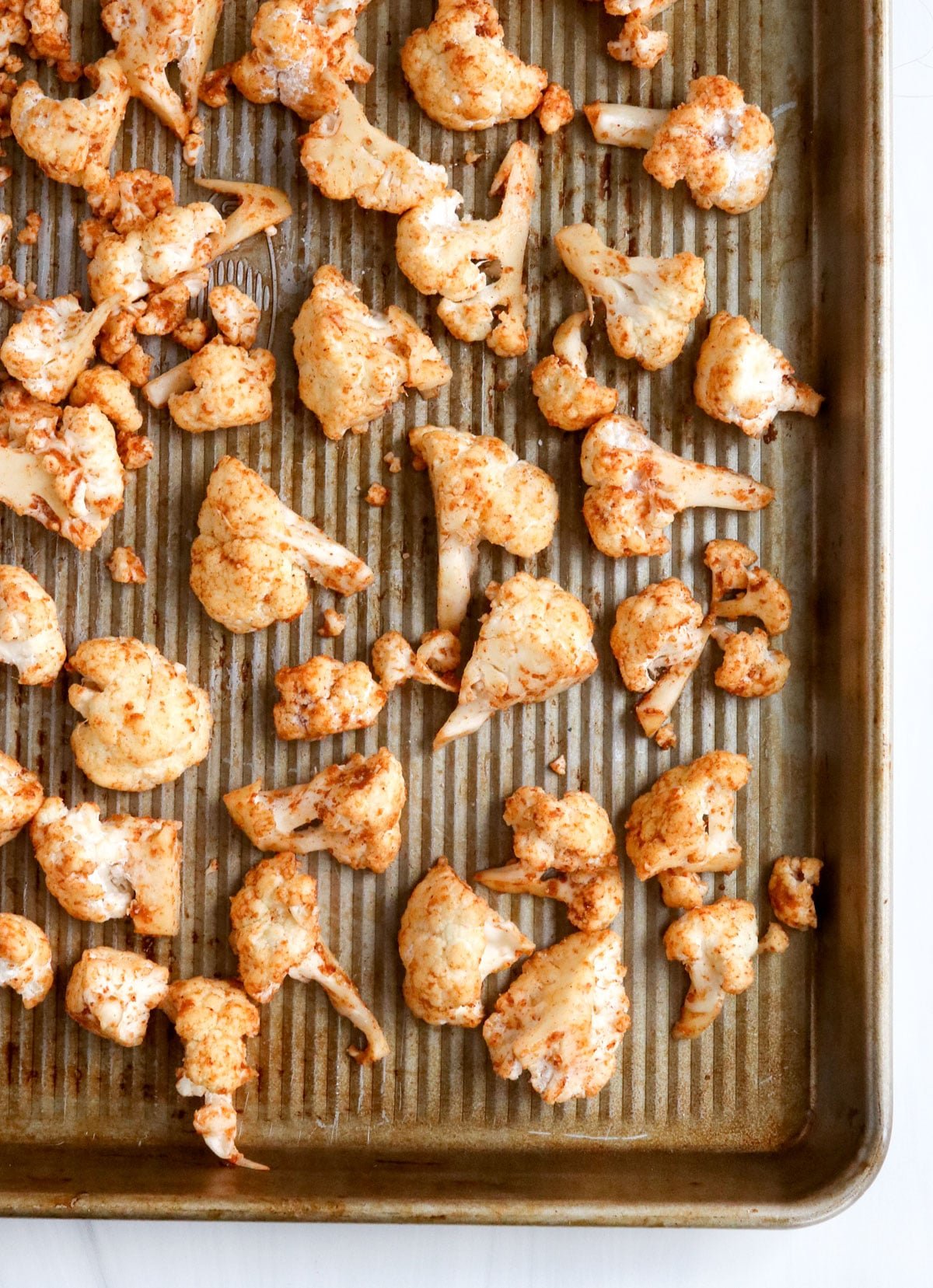 seasoned cauliflower on baking sheet