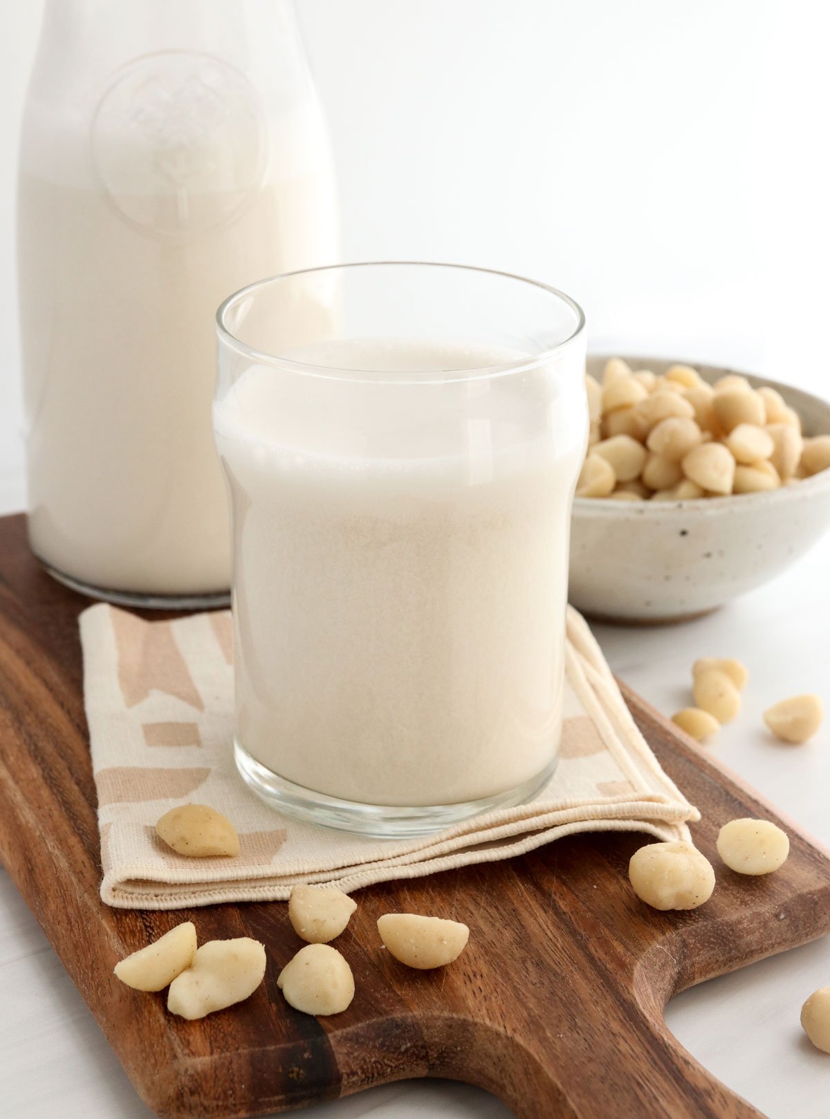 macadamia nut milk in glass and storage container