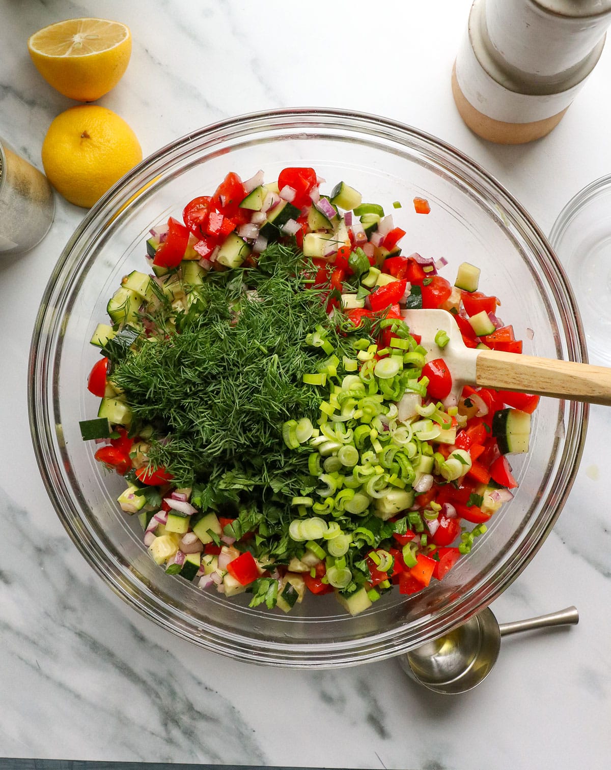 fresh dill, parsley, and green onion added to the quinoa salad bowl.