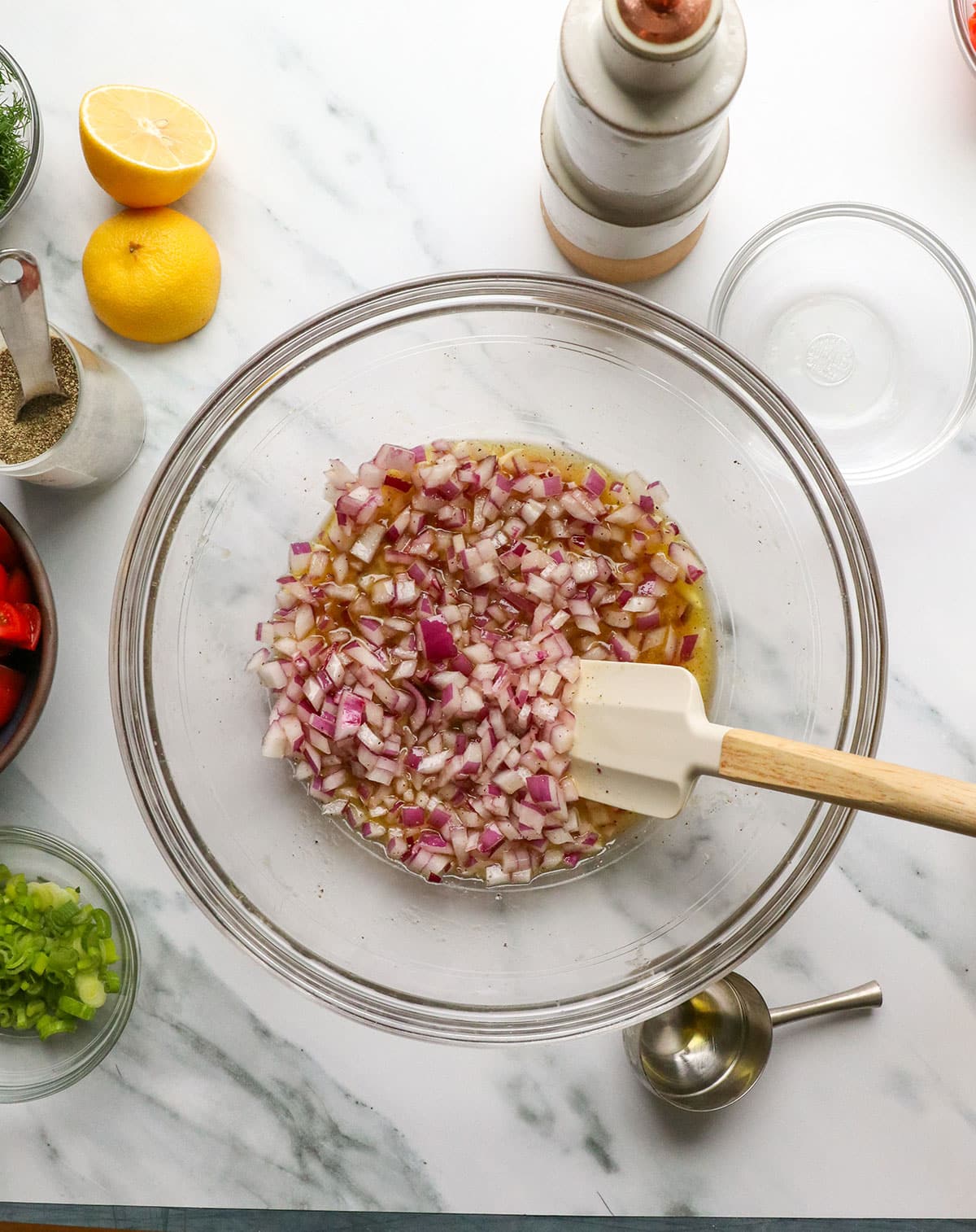 red onion in the bowl of dressing.
