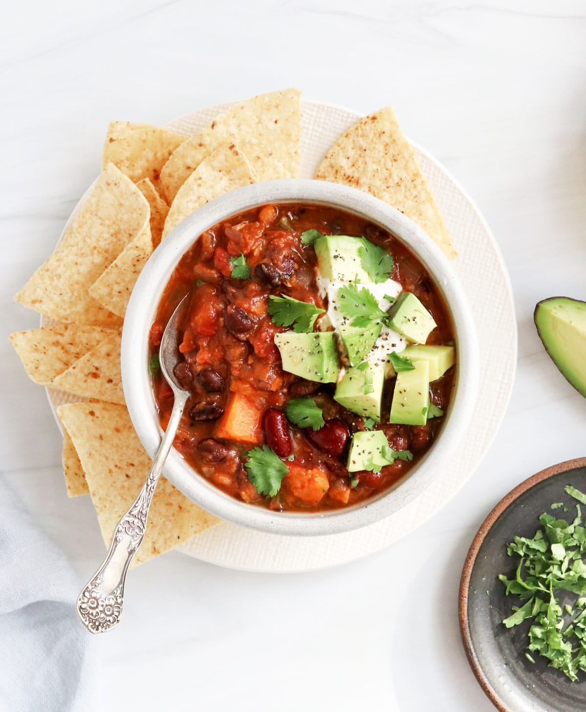 veggie chili in bowl with avocado on top
