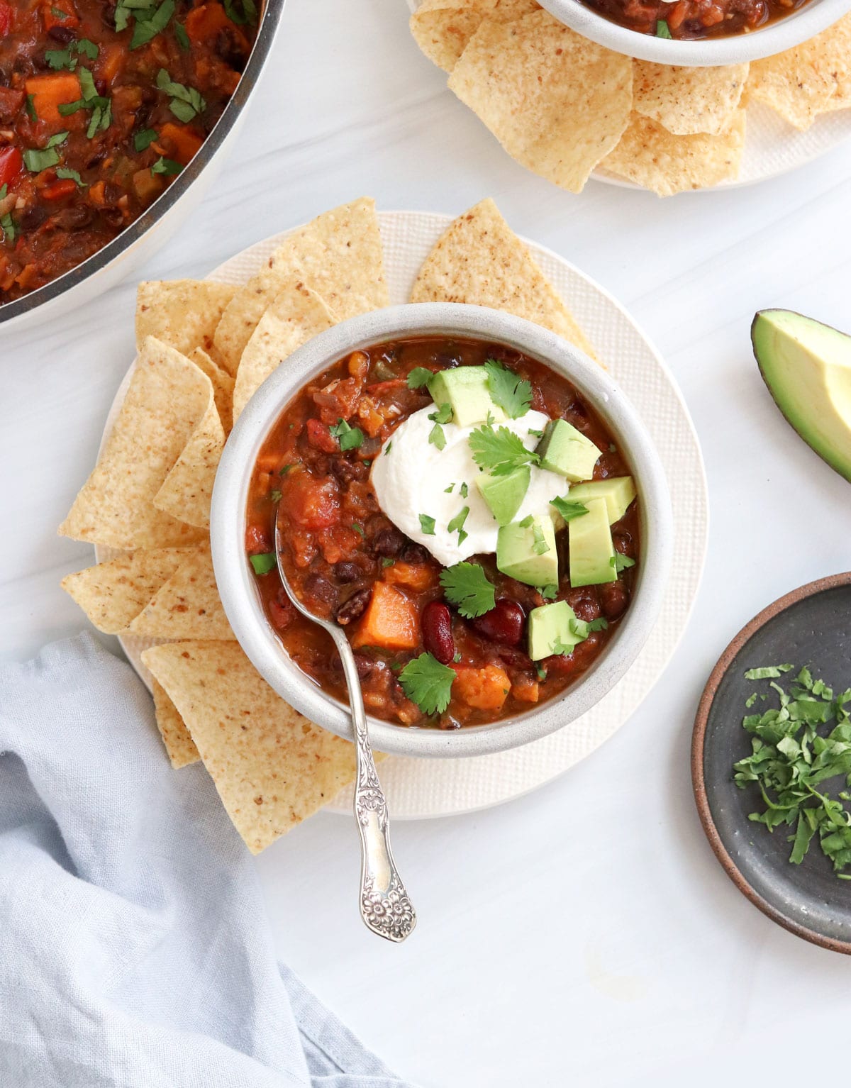 veggie chili in bowl with sour cream and avocado
