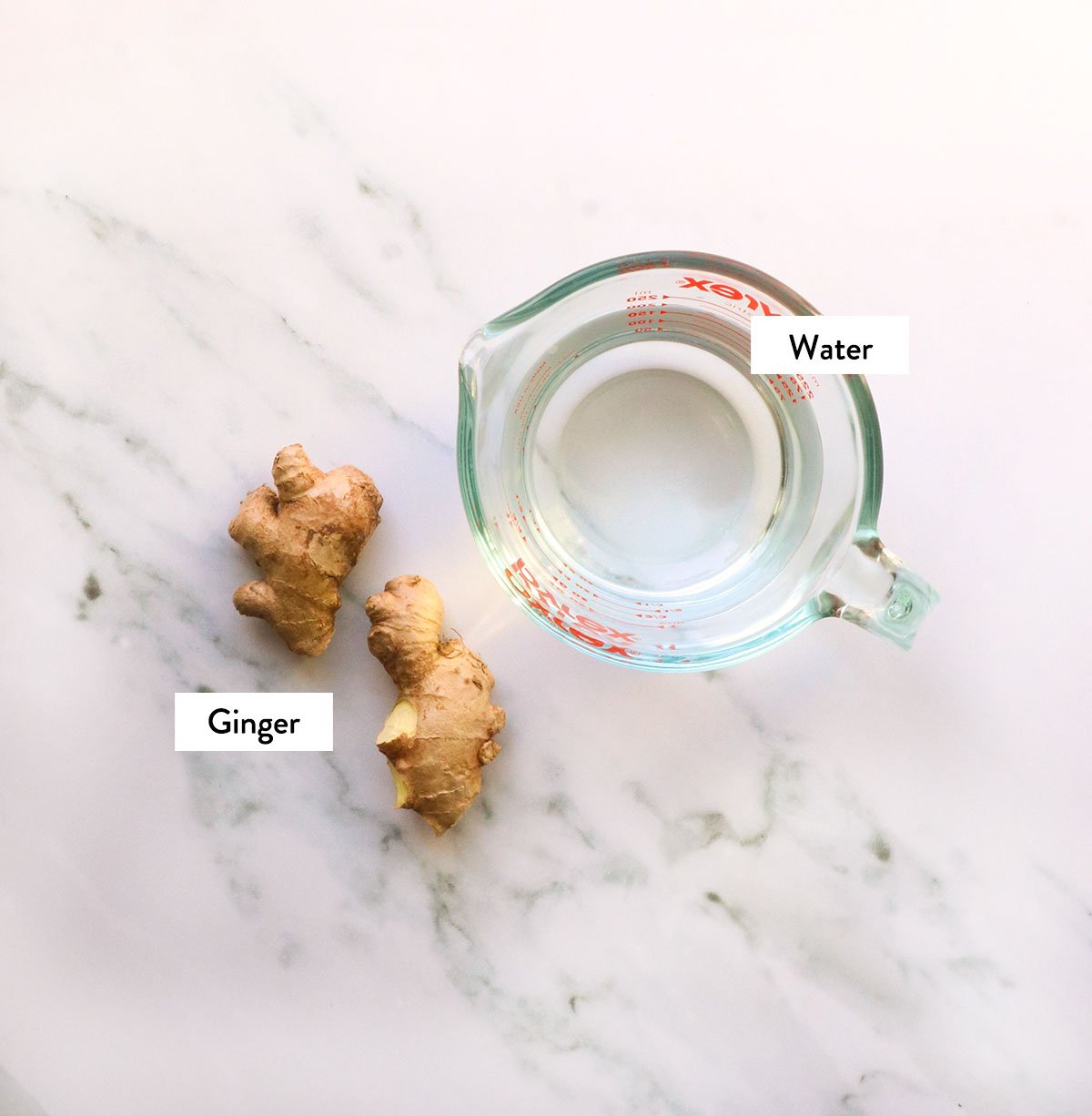 ginger and water labeled on a white surface.