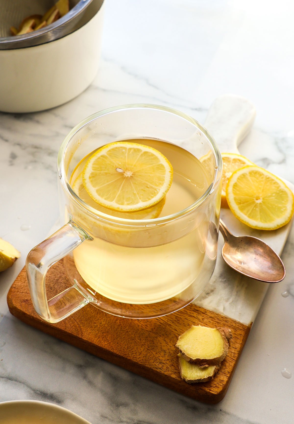 lemon slices in a glass mug of ginger tea.