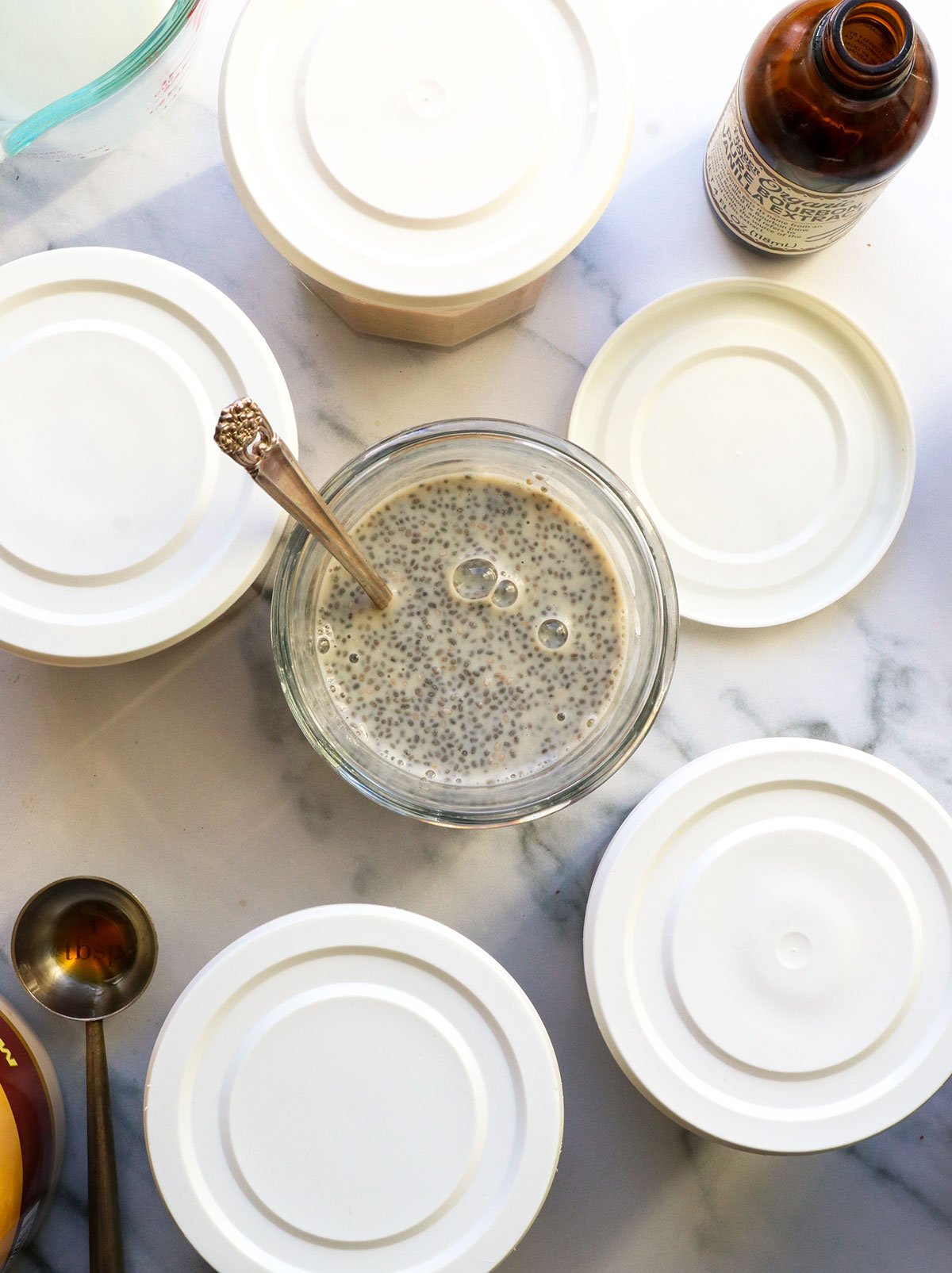 chia seed pudding stirred again with lids added to other jars.