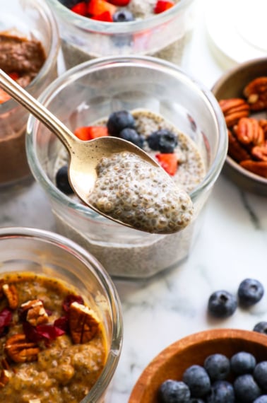 chia seed pudding close up on a spoon over a jar.
