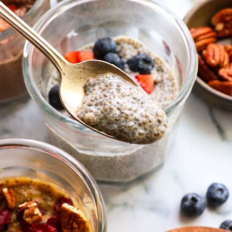 chia seed pudding close up on a spoon over a jar.