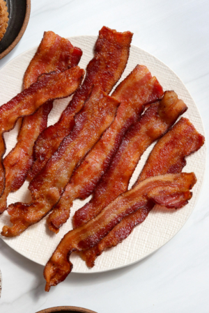 air fryer bacon on a white plate.