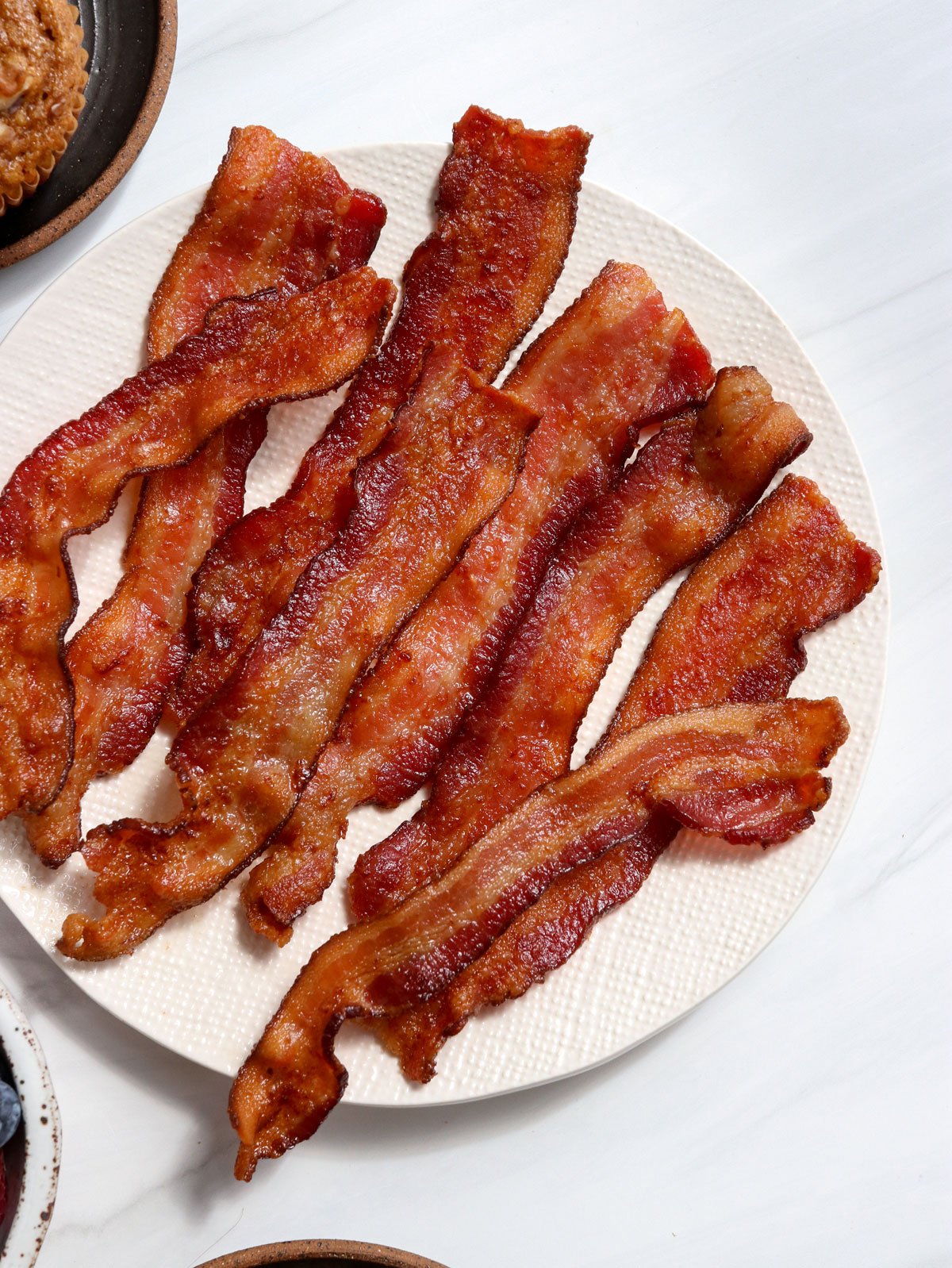 air fryer bacon on a white plate.