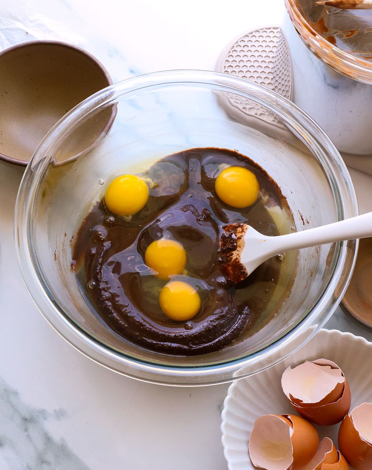 4 eggs cracked in to the chocolate mixture in the mixing bowl.