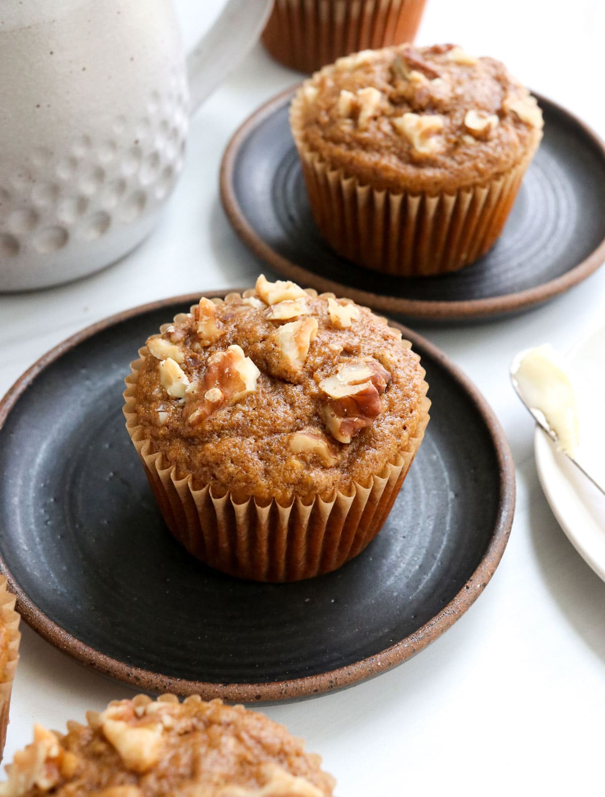 banana muffins with walnuts on top.