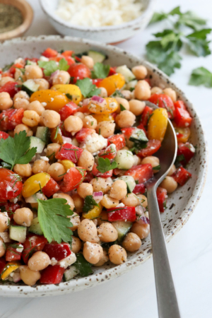 mediterranean chickpea salad with a serving spoon.