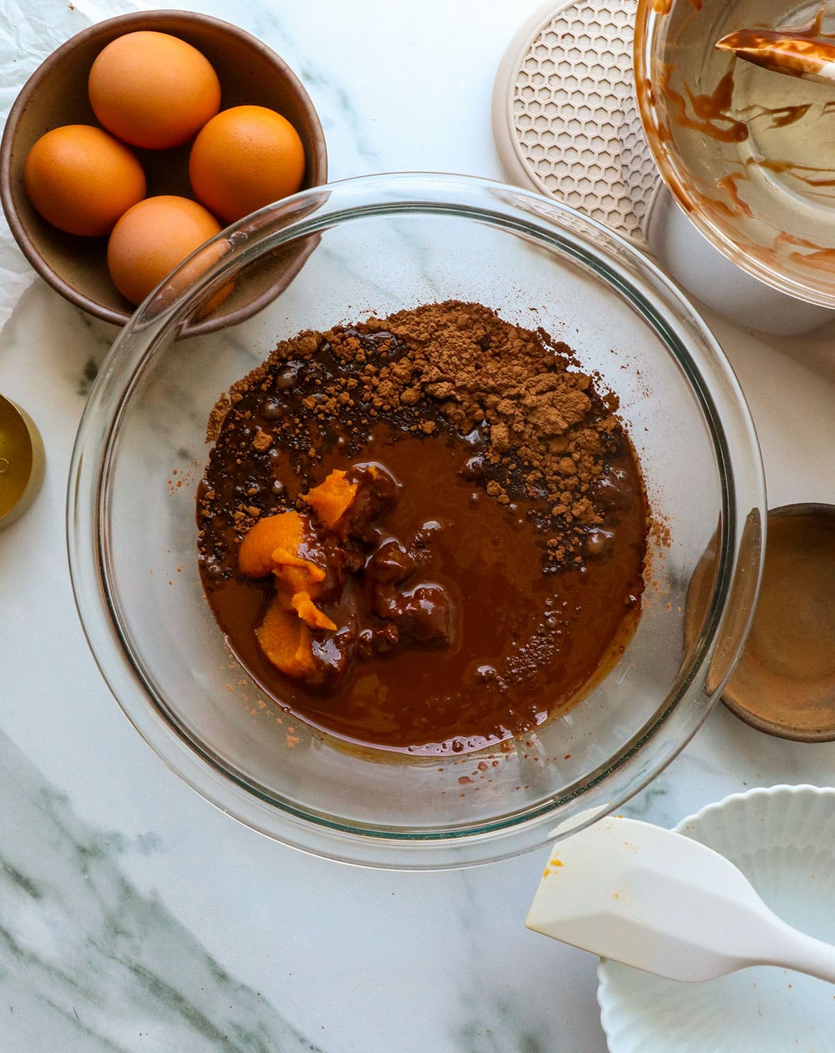 melted chocolate poured over the bowl of pumpkin and sugar.