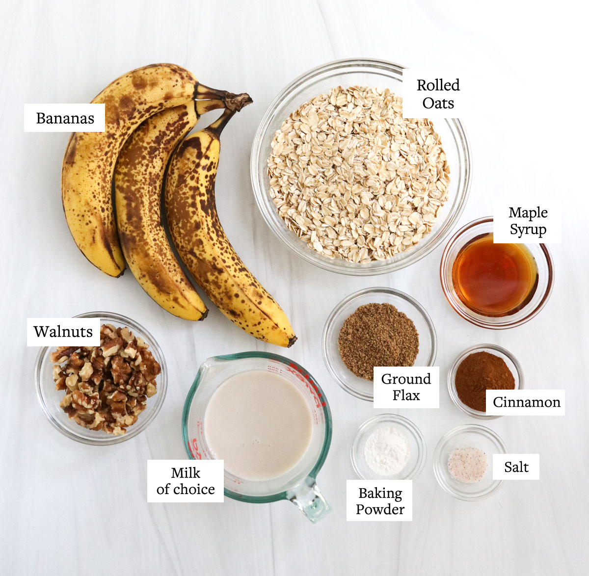 baked banana oatmeal ingredients on white surface.