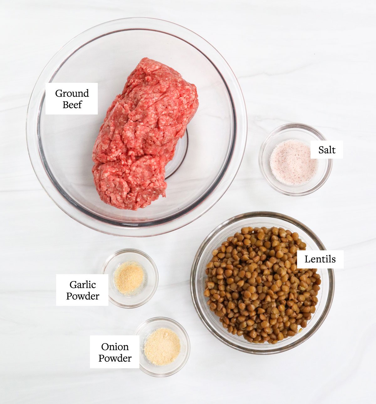 healthy burger ingredients in glass bowls.