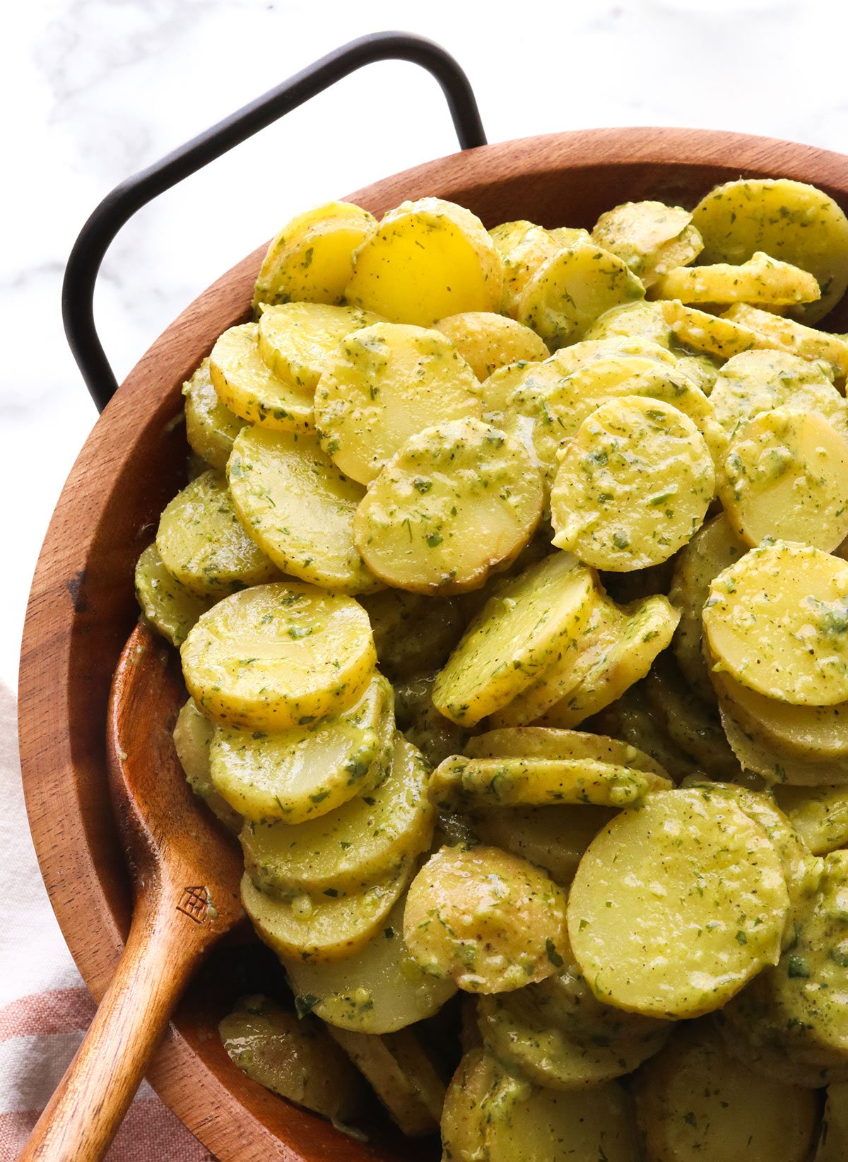 herbed potato salad served in a wooden bowl