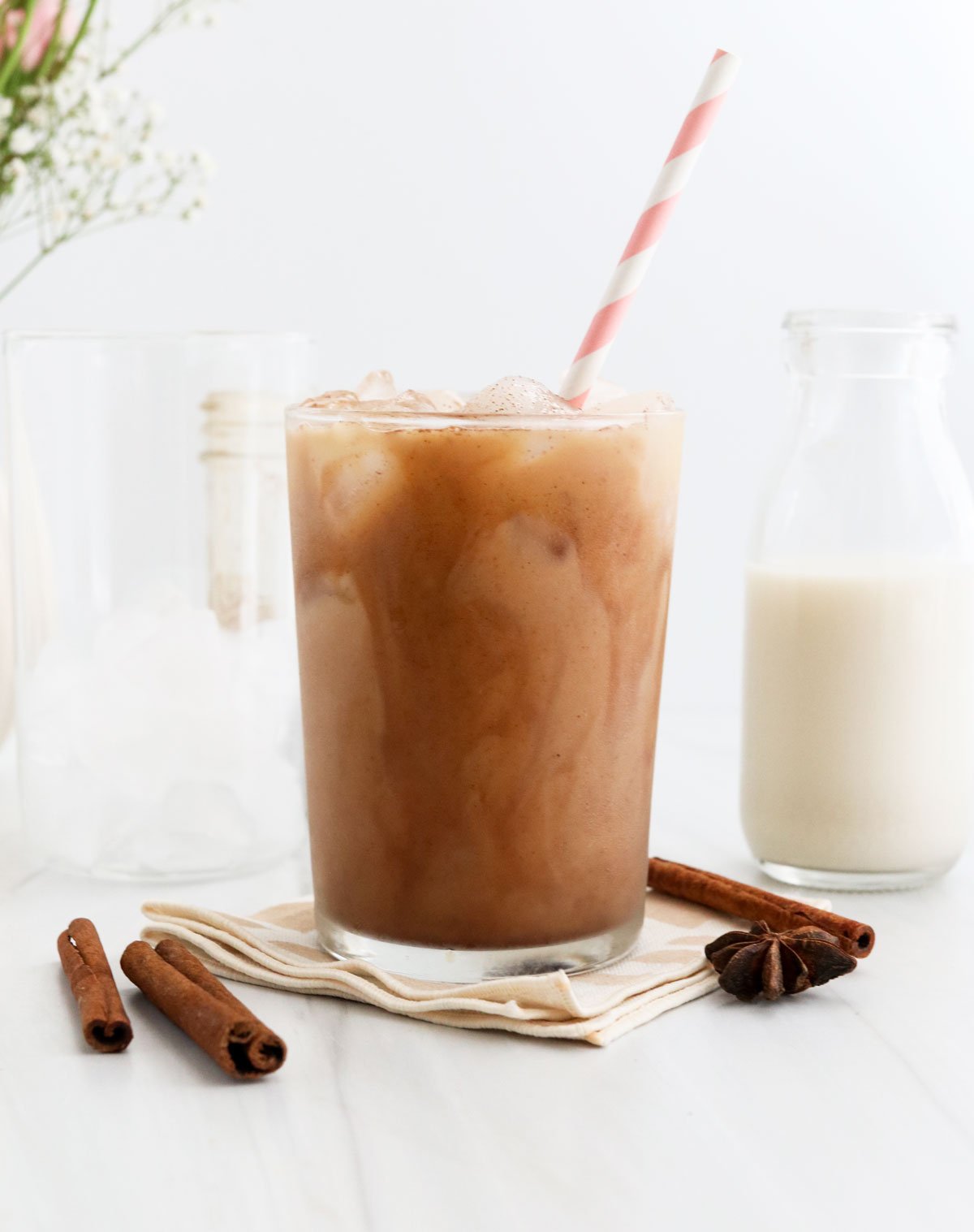 iced chai latte in glass with straw.