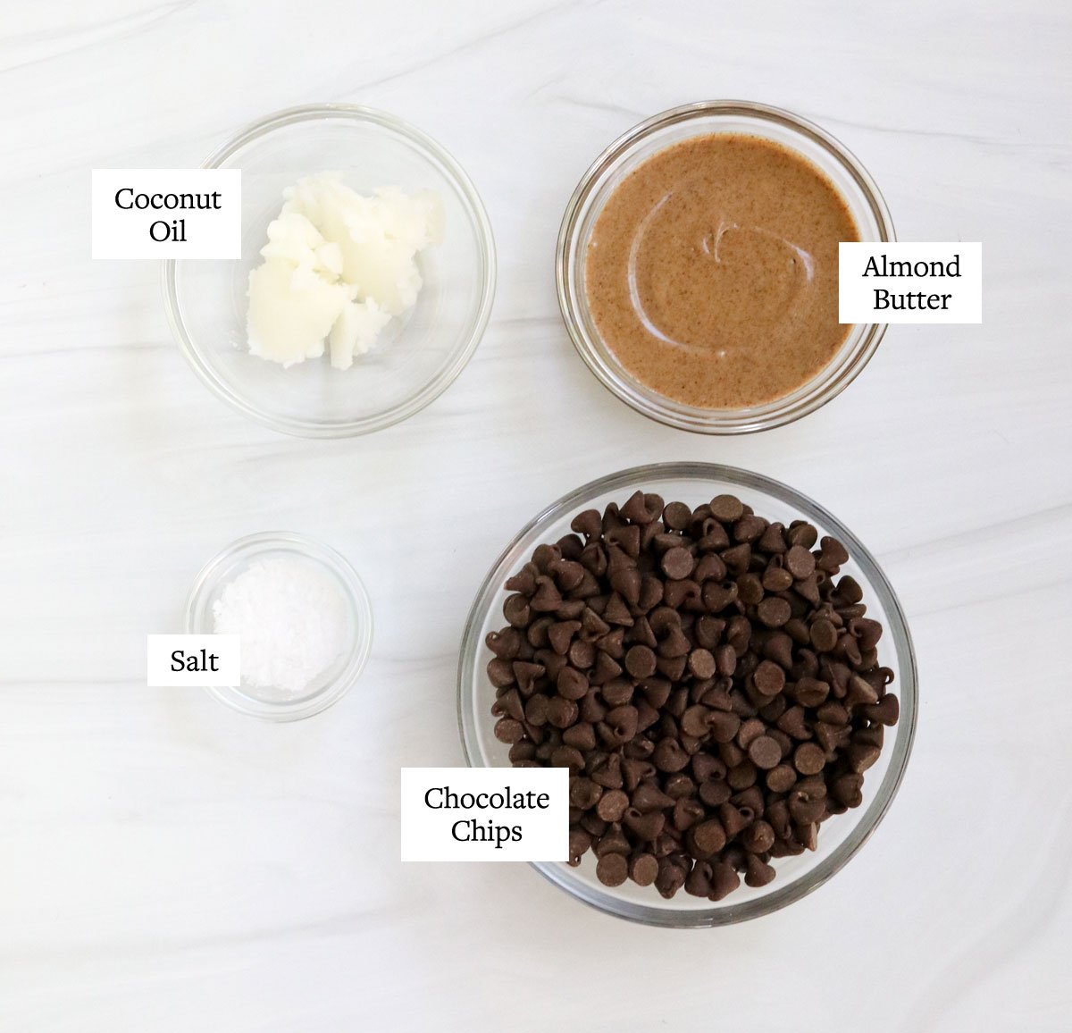 almond butter cup ingredients labeled in glass bowls.