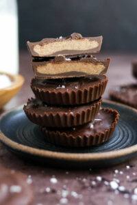 almond butter cups stacked on plate.
