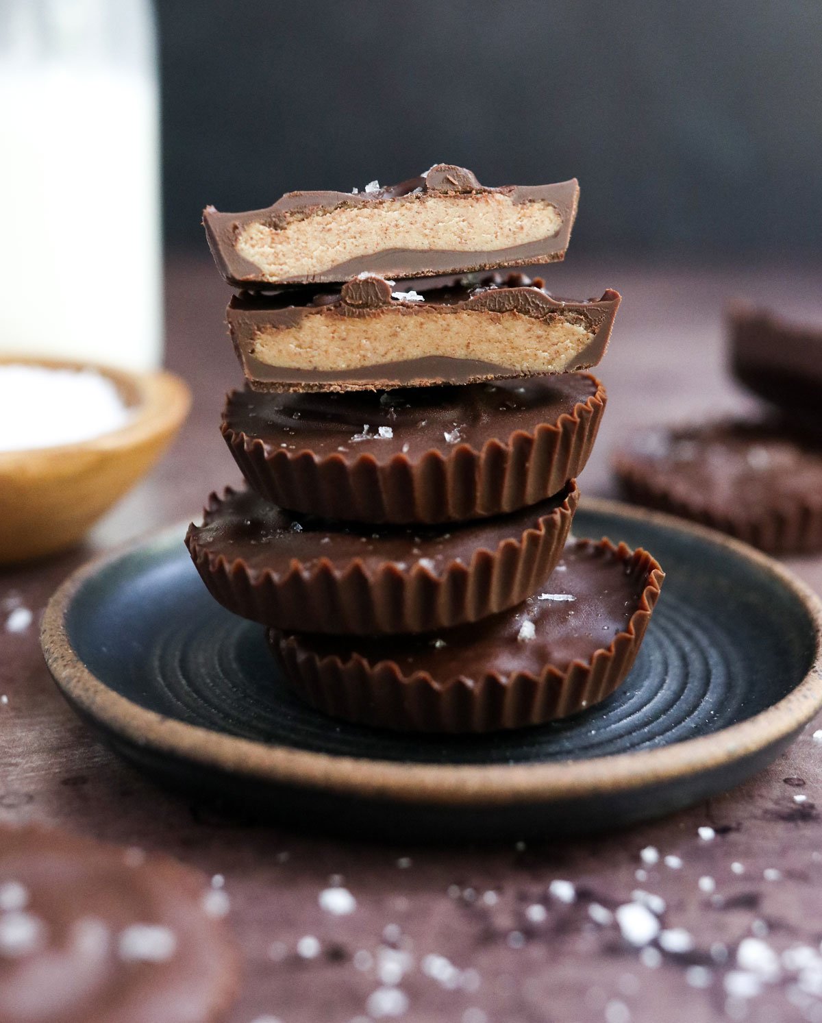almond butter cup cut in half and stacked on plate.