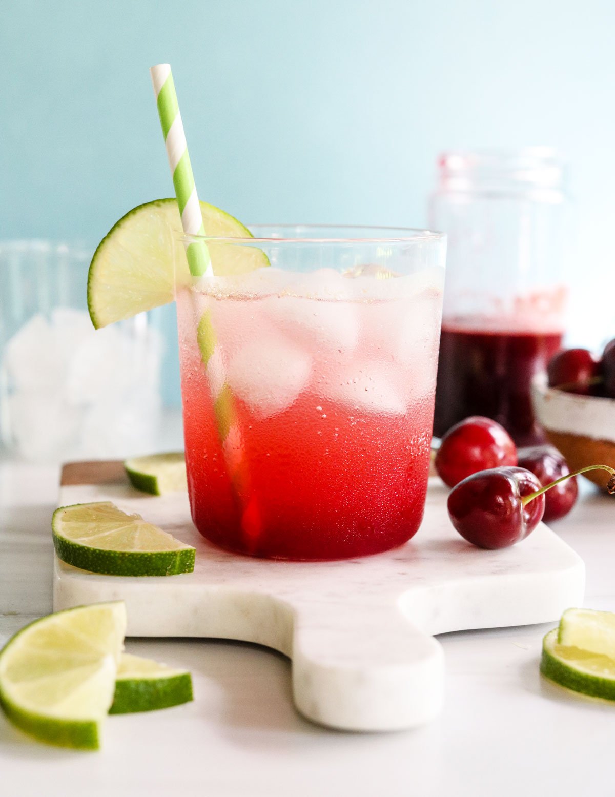 cherry limeade garnished with lime slices.