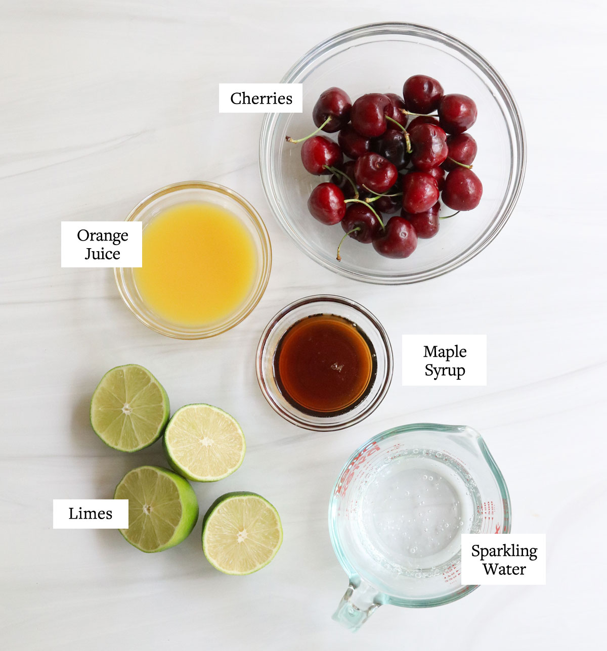 cherry limeade ingredients in glass bowls.