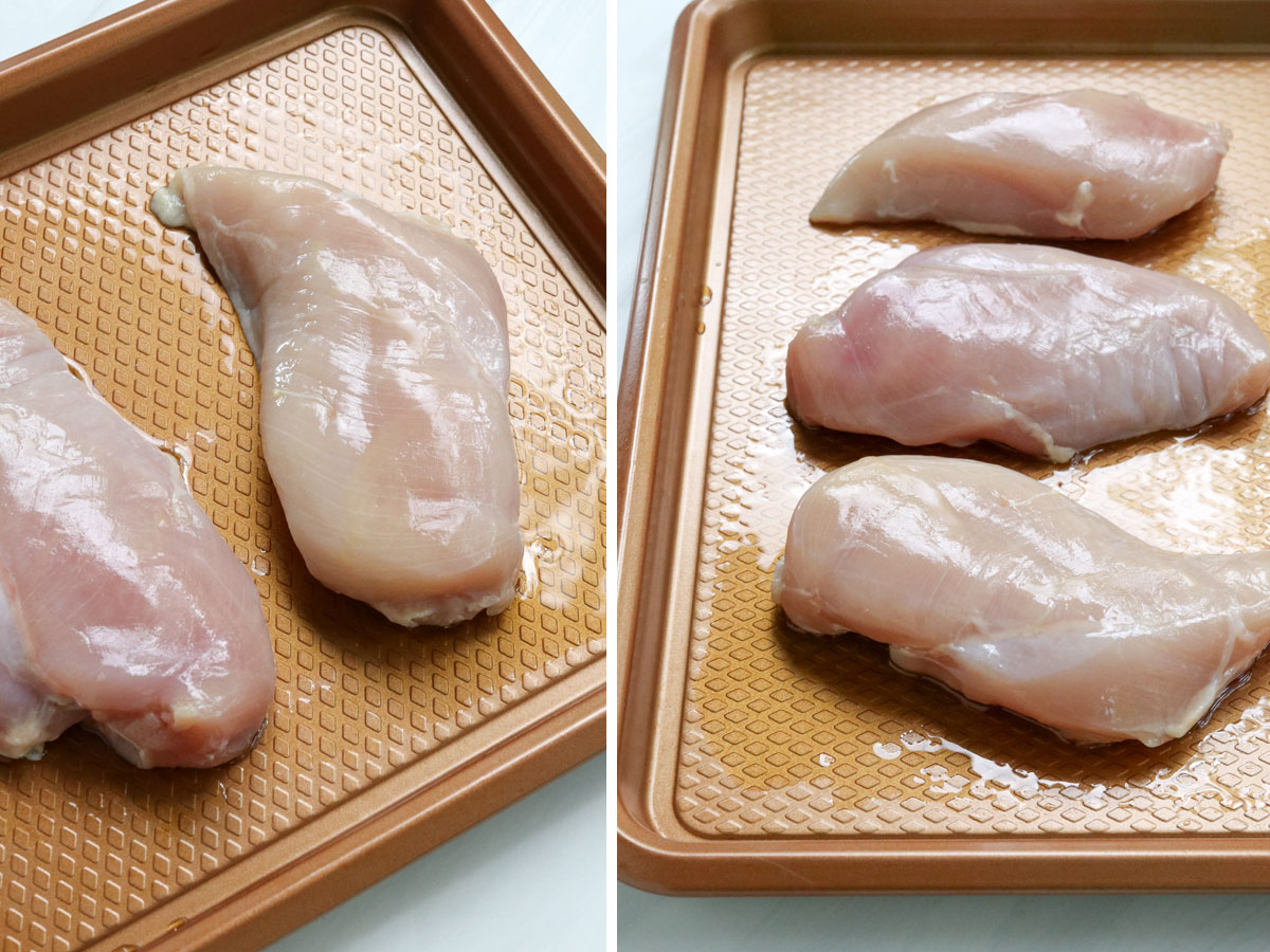 chicken breasts oiled on rimmed baking sheet.